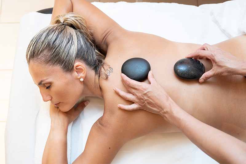 Lady enjoying hot stone massage at Mallorca Wellness SPA - Mediterraneo hotel
